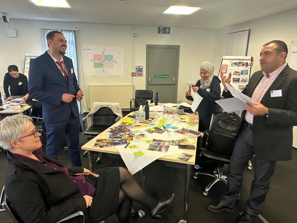 A group of people around a table as part of a workshop